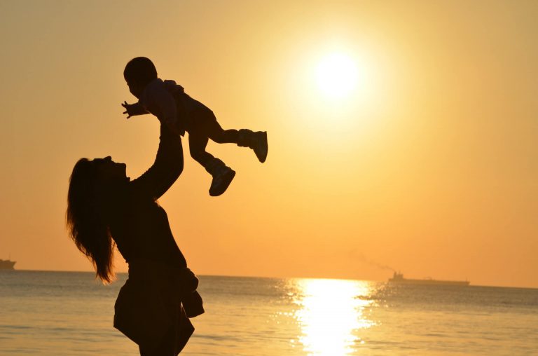 mother holding child correctly as instructed by an osteopath